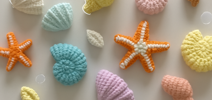 crocheted pastel seashell amigurumi flat lay